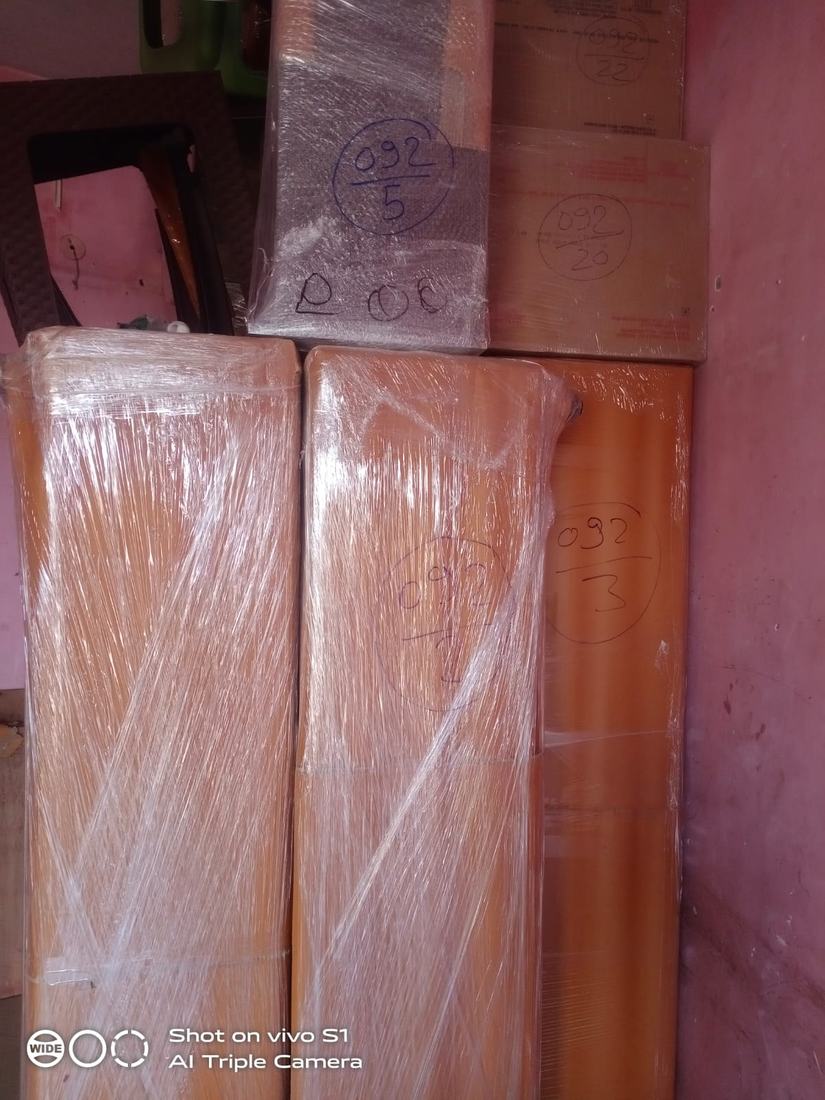 Wrapped furniture panels labelled with inventory numbers